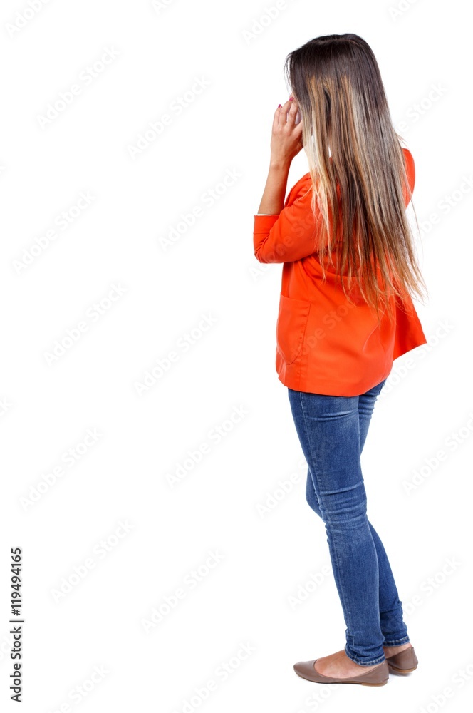 back view of standing young beautiful woman using a mobile phone or tablet computer. girl watching. Rear view people collection. backside view of person. Isolated over white background. girl in a back view of standing young beautiful woman using a mobile phone or tablet computer. girl watching. Rear view people collection. backside view of person. Isolated over white background. girl in a