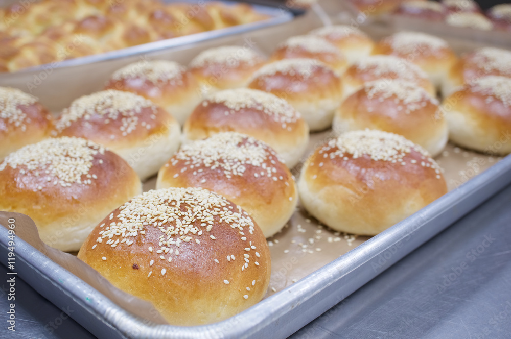 Bread baked with white sesame on aluminium oven tray
