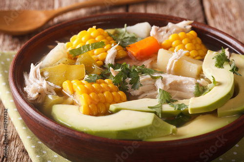 Delicious potato soup ajiaco close up in a bowl. horizontal
