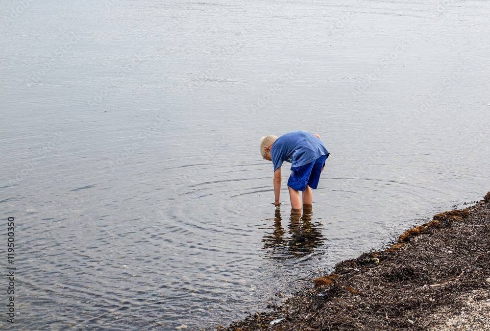 one little boy who are walking in the water one little boy who are walking in the water