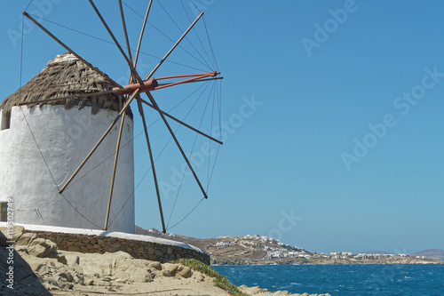Mykonos, Greece. Traditional windmill with a view to Mykonos island. Over 16 windmills can be found in Mykonos.