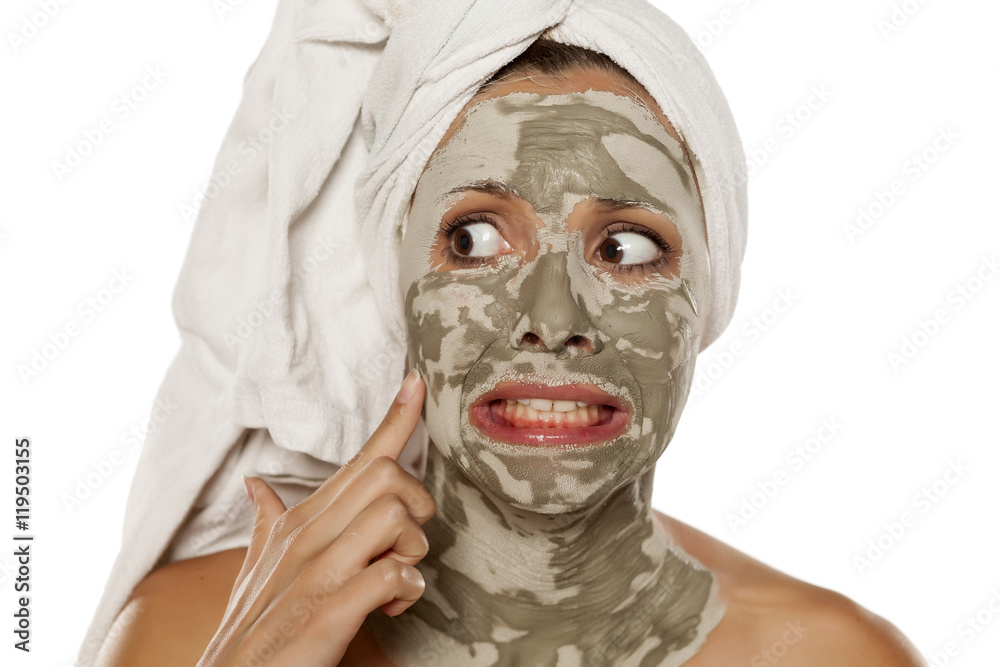 Fototapeta premium beautiful nervous woman with a mud mask on her face