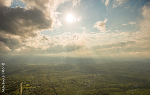 Tableau sur toile Aerial Photos. The sun's rays make their way through the clouds.