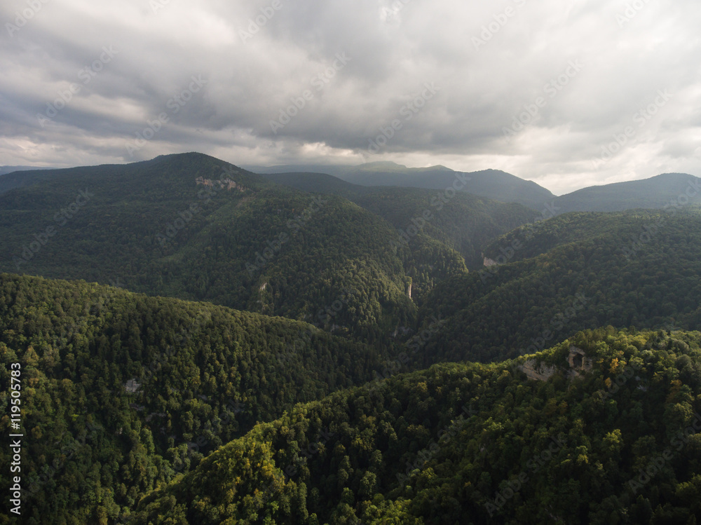 Aerial view. Caucasus Mountains under gloomy cloudy sky. Aerial view. Caucasus Mountains under gloomy cloudy sky.