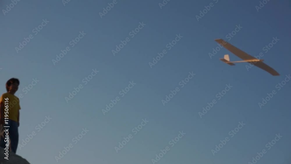 Slow motion: Happy Child Playing with an airplane on a meadow Slow motion: Happy Child Playing with an airplane on a meadow