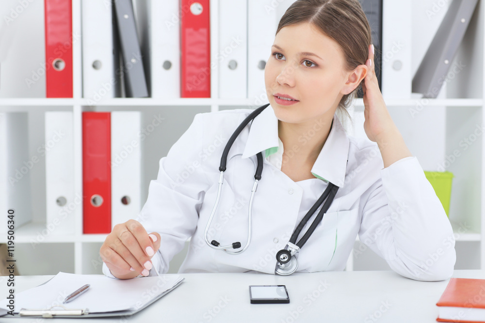 Female doctor preparing for patient admission. Female doctor preparing for patient admission.