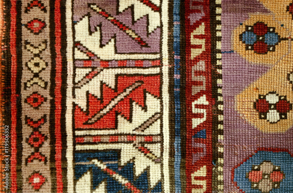 The edge ethnic woolen rug with sample  of the folk geometric ornaments

