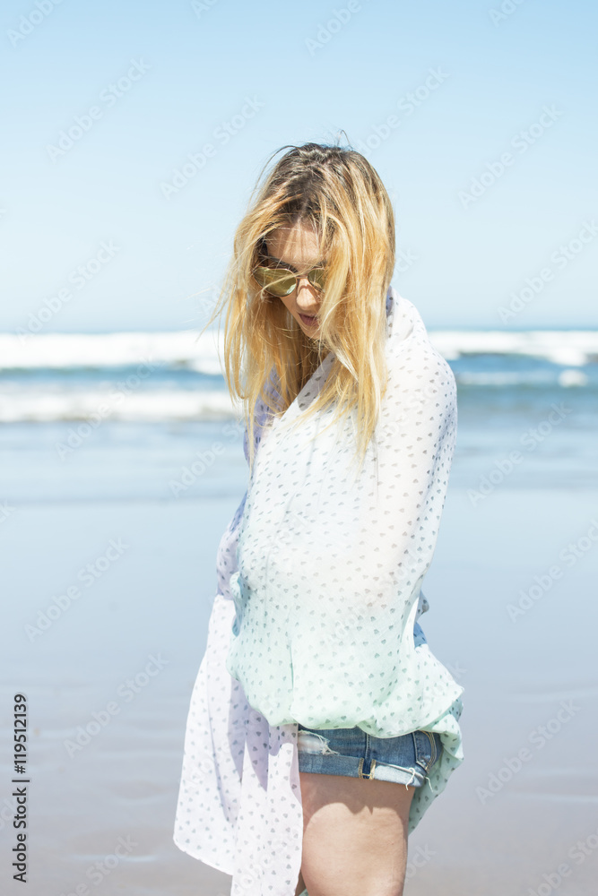 Beautiful woman wrapped in towel and relaxing in the beach. Beautiful woman wrapped in towel and relaxing in the beach.