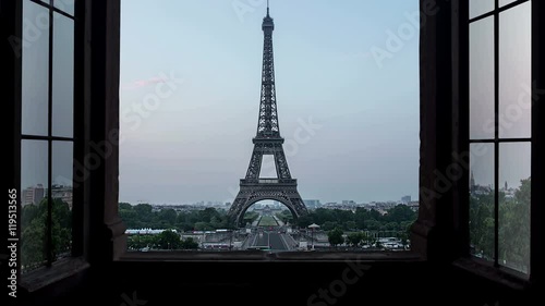 unusual view of the eiffel tower seen from a window time lapse from night to day sunrise,new day birth over paris 4k