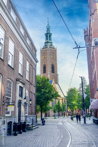 Pretty European city with clock tower near street