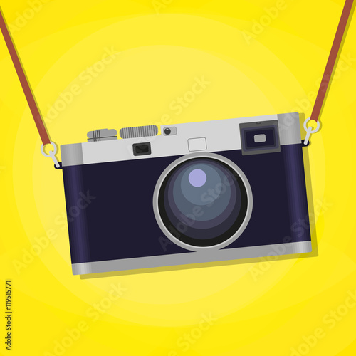 Old photographic camera isolated over yellow background