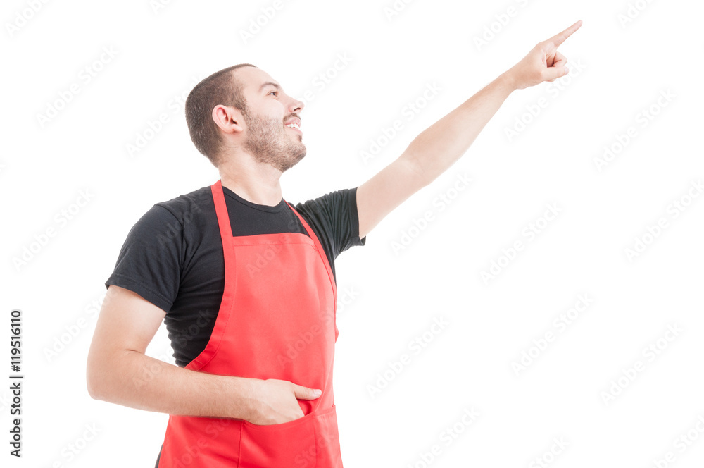 Friendly hypermarket employee pointing up Friendly hypermarket employee pointing up