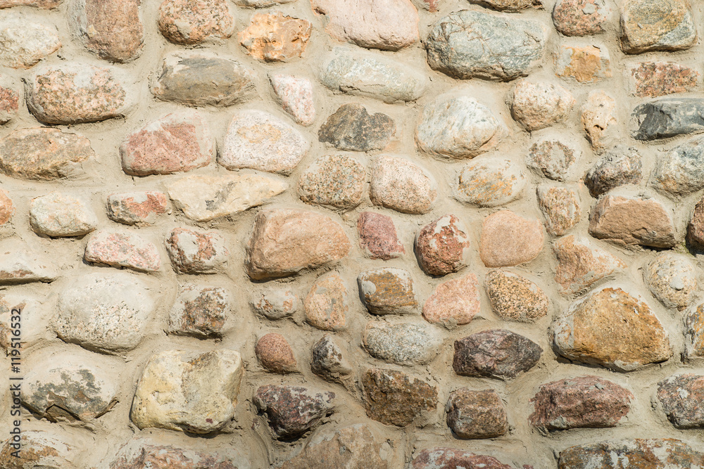 wall made of natural round stone background wall made of natural round stone background