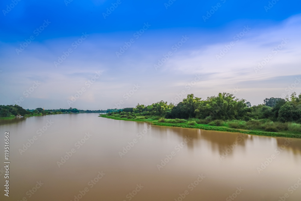 Calm turbid water in river with water hyacinth : beautiful blue sky clouds at twilight time - Beautiful Nature composition.