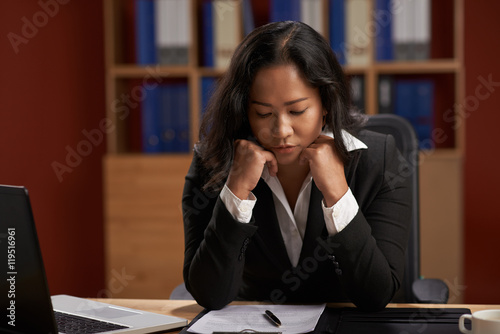 Business lady reading agreement in her office