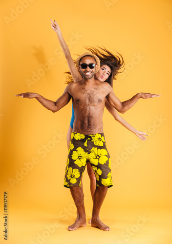 Loving smiling couple in swimwear having fun