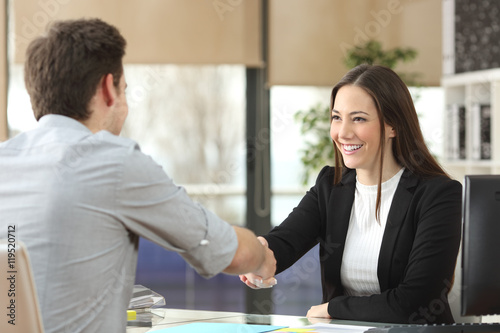 Businesswoman handshaking with client closing deal