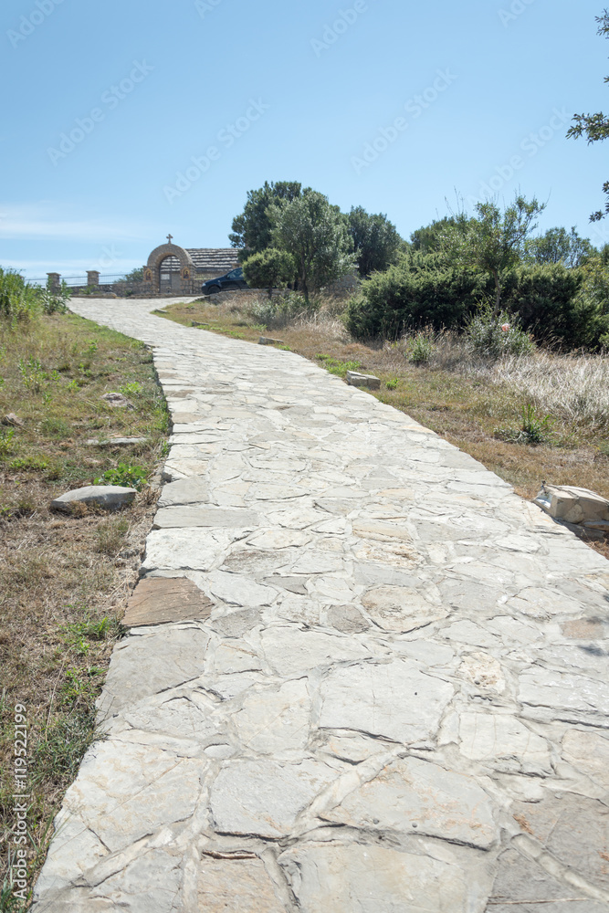 Rocky road to the hill with church on the top