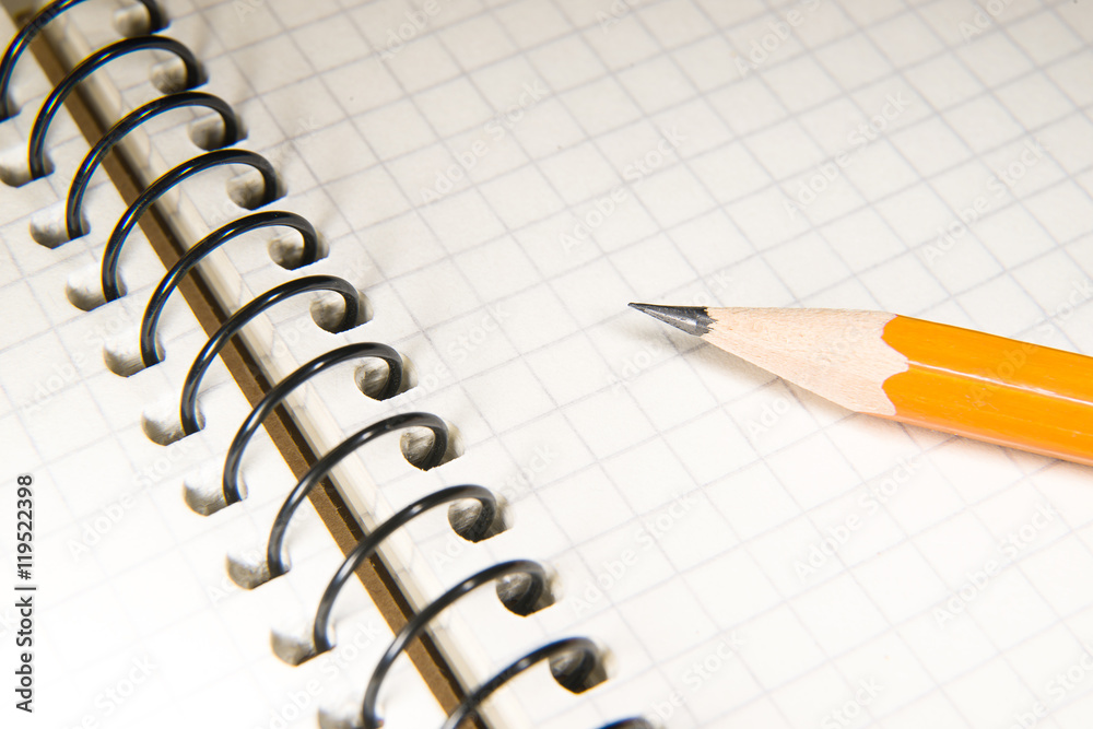Opened notebook and pencil on over white Opened notebook and pencil on over white