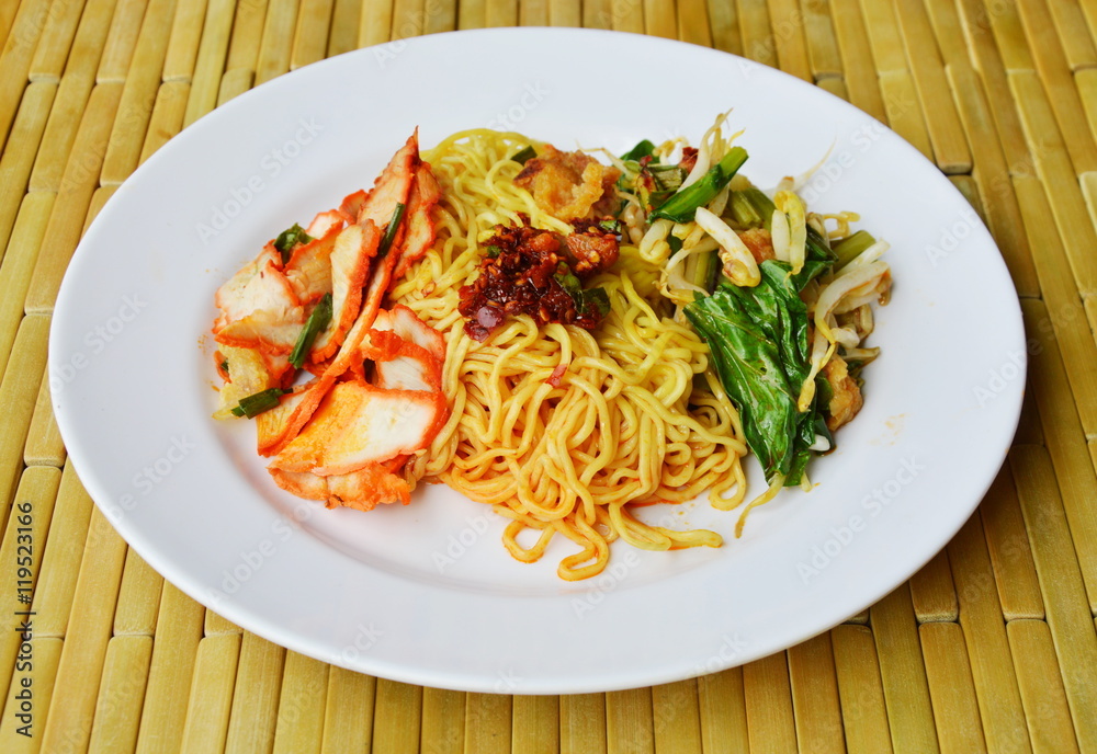 Chinese egg noodle with barbecue pork and vegetable topping chili paste on dish