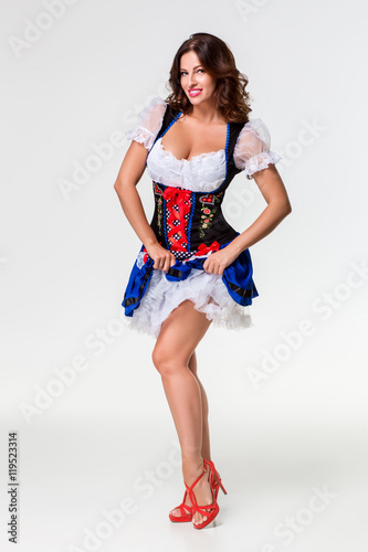 Fotografie Beautiful young brunette girl of oktoberfest stein