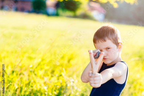 Fényképezés Little boy playing with slingshot