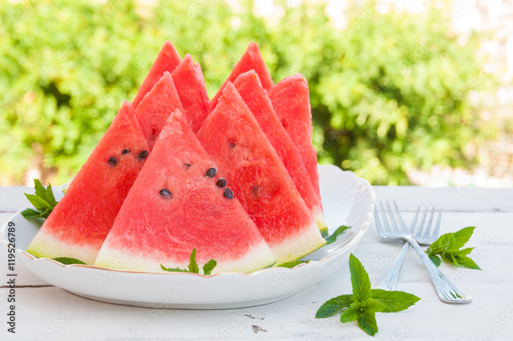 Slices of watermelon in a plate on wooden table Slices of watermelon in a plate on wooden table