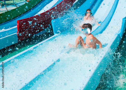 Fotografie Two children on water slide in aqua park