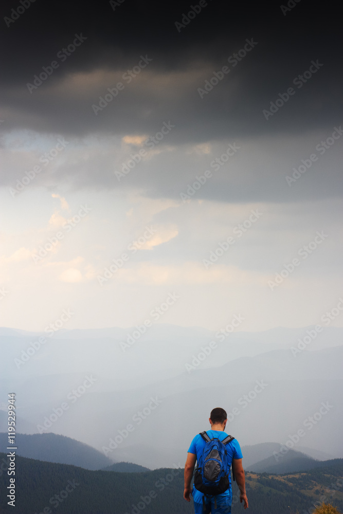 Tourist on top of mountain. Man relax and enjoy beautiful panorama of mountain ranges. Rest in mountains. Mountain landscape