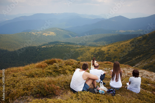 Tourists on top of mountain. Group of people relax and enjoy beautiful panorama of mountain ranges. Rest in mountains. Mountain landscape