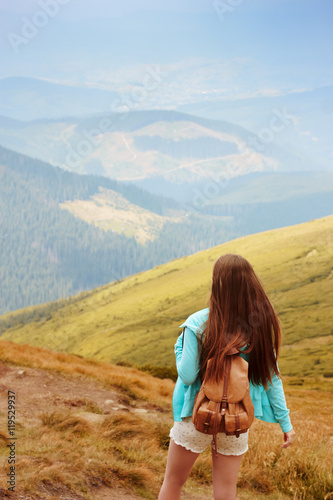 Tourist on top of mountain. Girl relax and enjoy beautiful panorama of mountain ranges. Rest in mountains. Mountain landscape