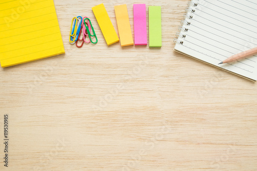Top view of stationery items on wooden background