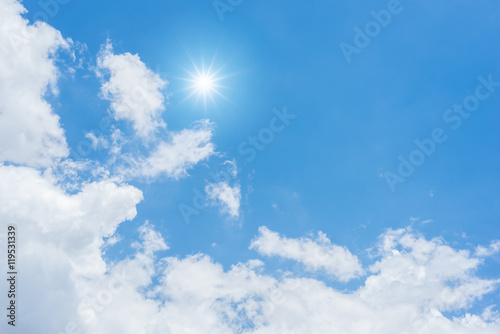Blue sky with clouds and sun reflection. looking up view
