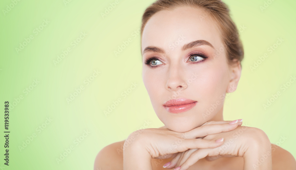 Naklejka premium beautiful young woman face and hands