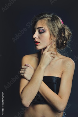 Spring model with flowers in her hair and fashion makeup . Summer girl with trendy make up and hairstyle .