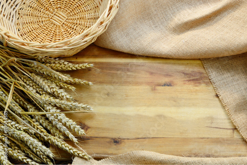 Empty wooden cutting board and basket with wheat,Sackcloth for backgrounds or wallpaper. 
