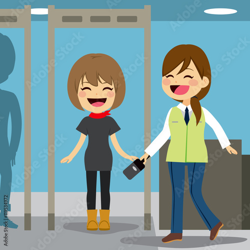 Worker scanning woman passenger at checkpoint with metal detector airport security device