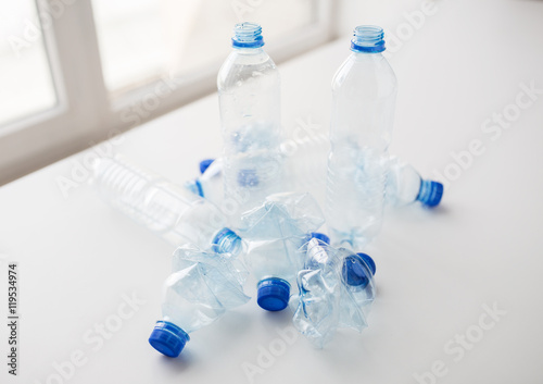close up of empty used plastic bottles on table