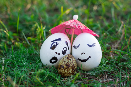 Funny eggs imitating white mother and father with versicolored b photo