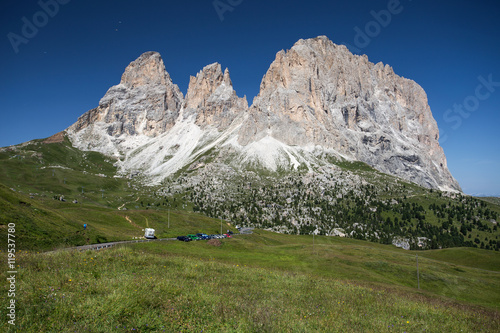 Sassolungo, Val Gardena, Dolomites, Italy. The Sassolungo alp standing over colorful fields during the summer season in Val Gardena, Trentino Alto Adige, Italy.