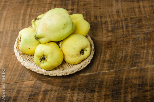 Yellow quince on wooden table