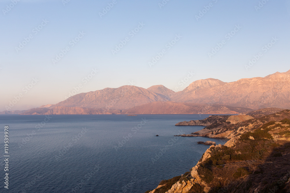 Beautiful and peaceful sea with mountains at sunset