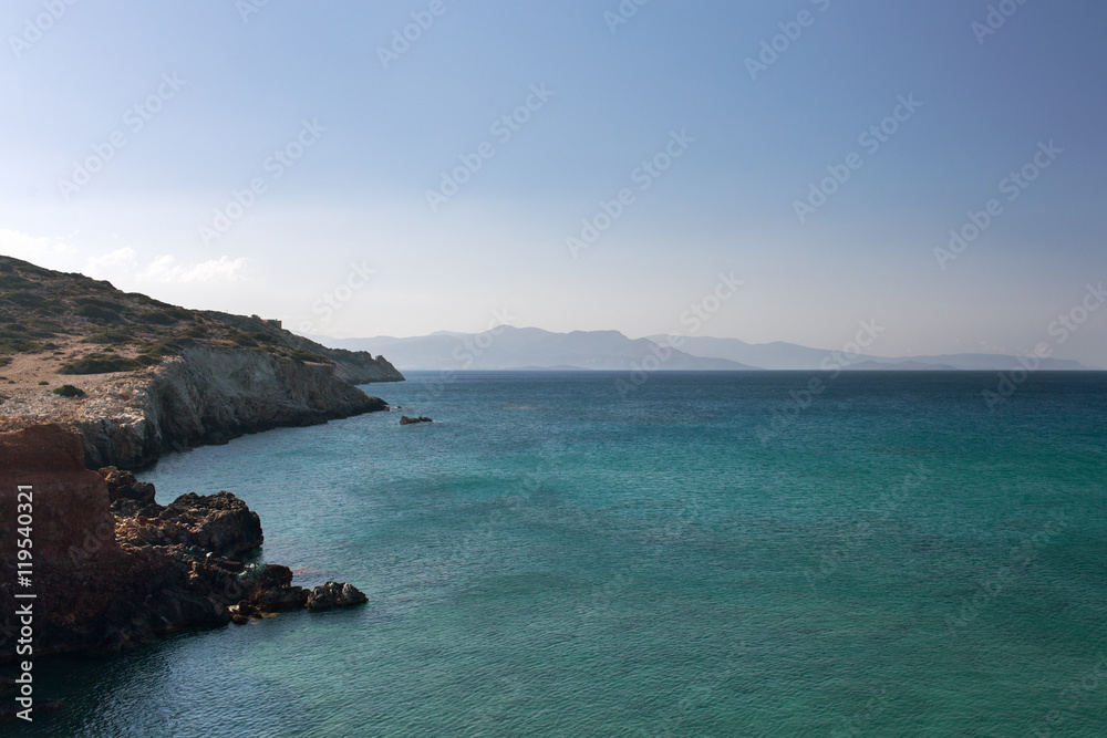 The sea of different colors of blue surrounded by mountains