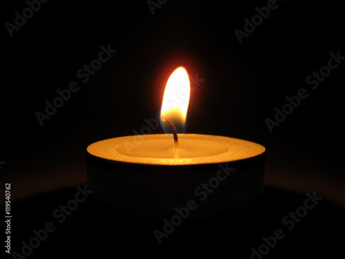 Bright burning candle in the dark