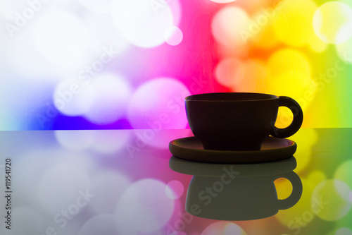horizontal photo of silhouette coffee cup on colorful bokeh background