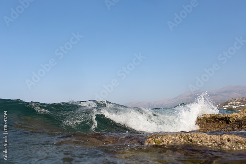 Sea Wave and foam on a background of mountains