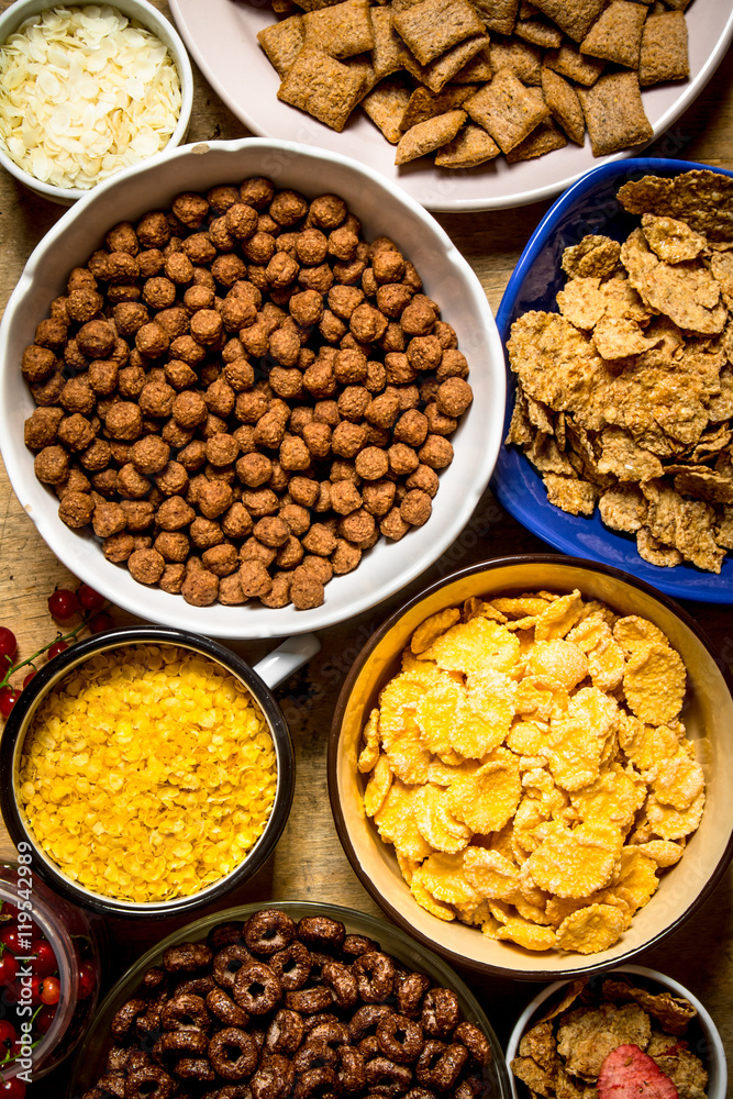 Cereal in cups. On wooden background.