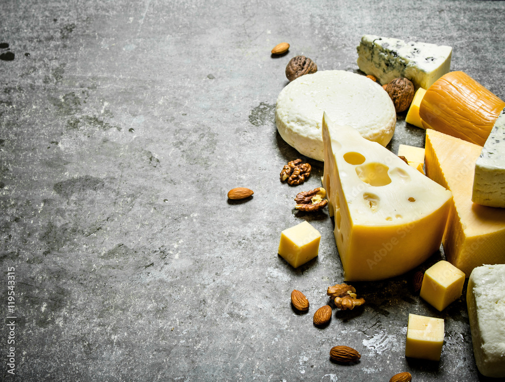 Fototapeta premium Pieces of different cheeses with walnuts.