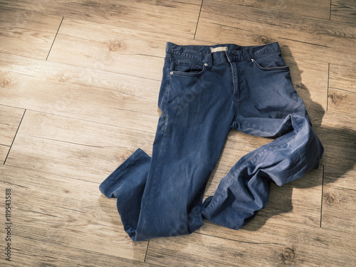 indigo navy blue pants on wooden background ( Composition and space for text )