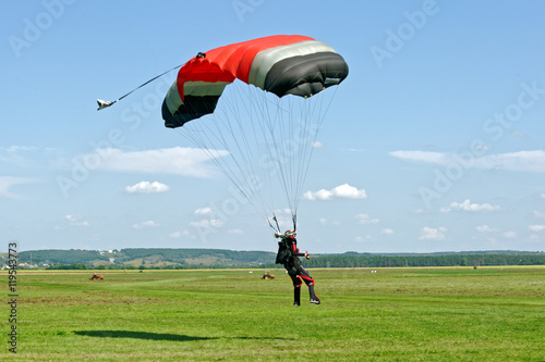 Paraglider landed after the jump at a bright sunny summer day. Active lifestyle, extreme hobbies